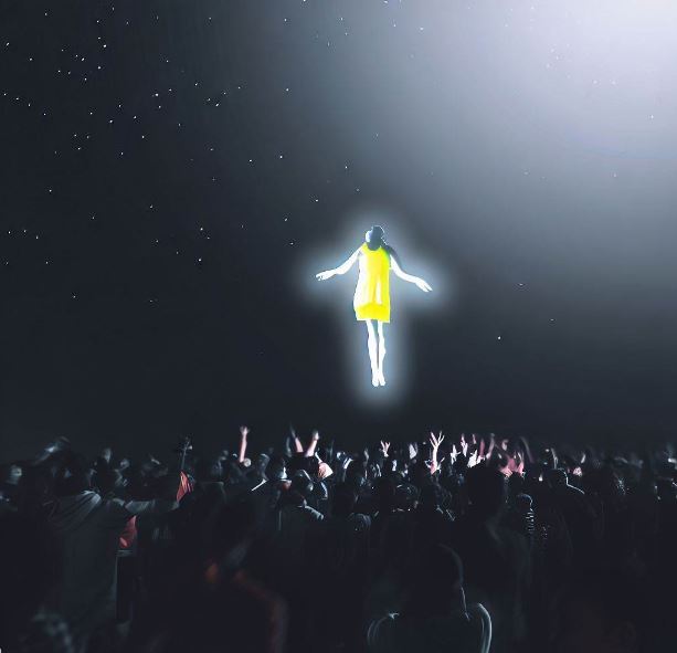 An image of someone floating above a crowd.